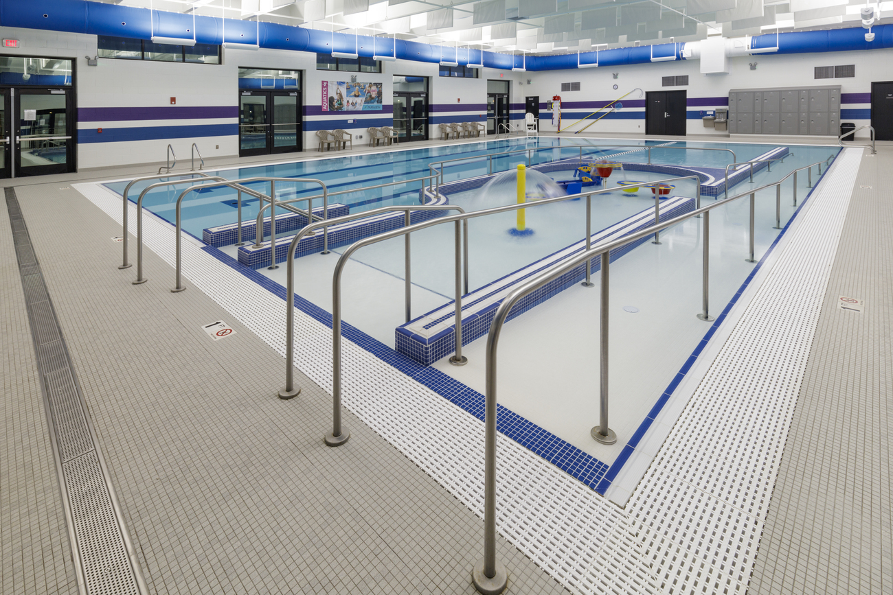 Indoor commercial pool with entry ramp.