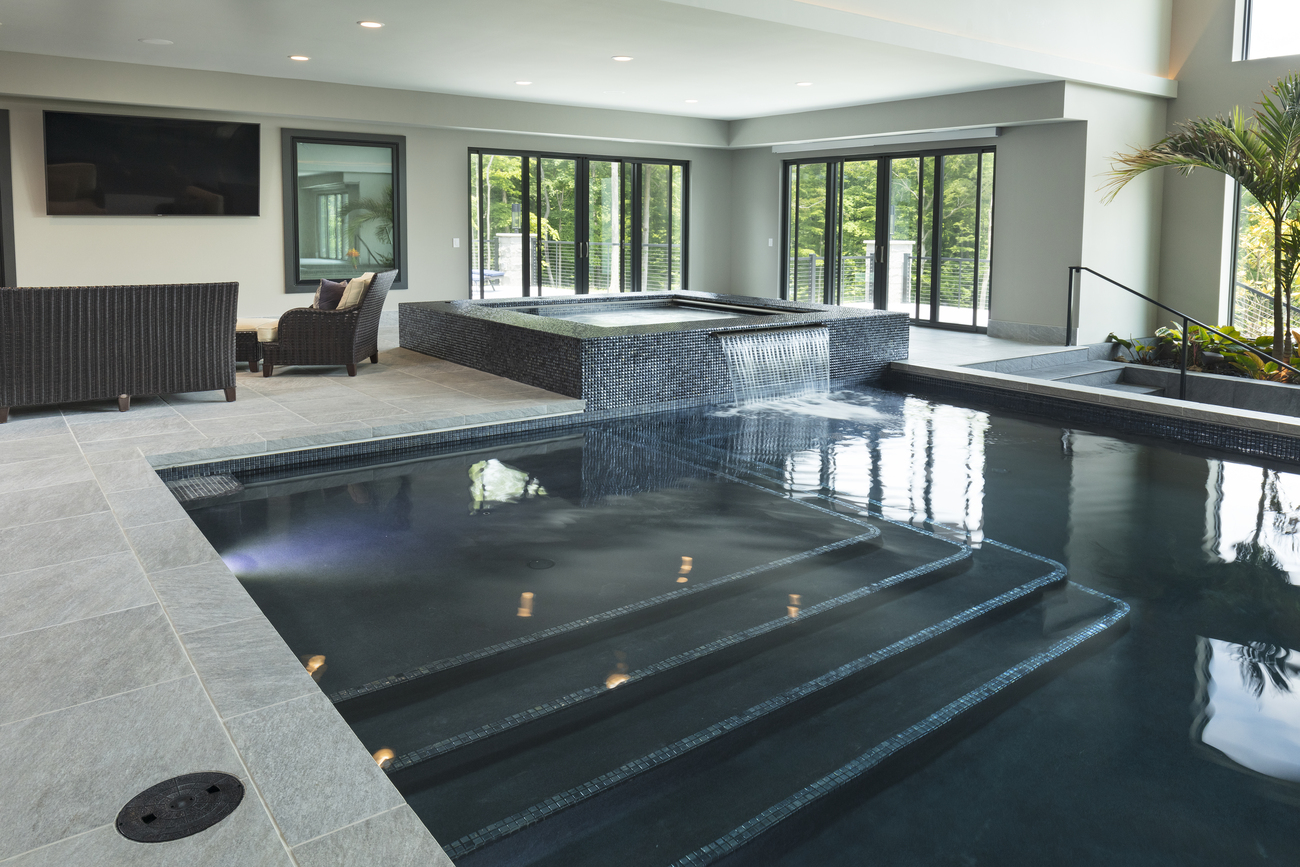 Indoor residential pool with large tiled steps.