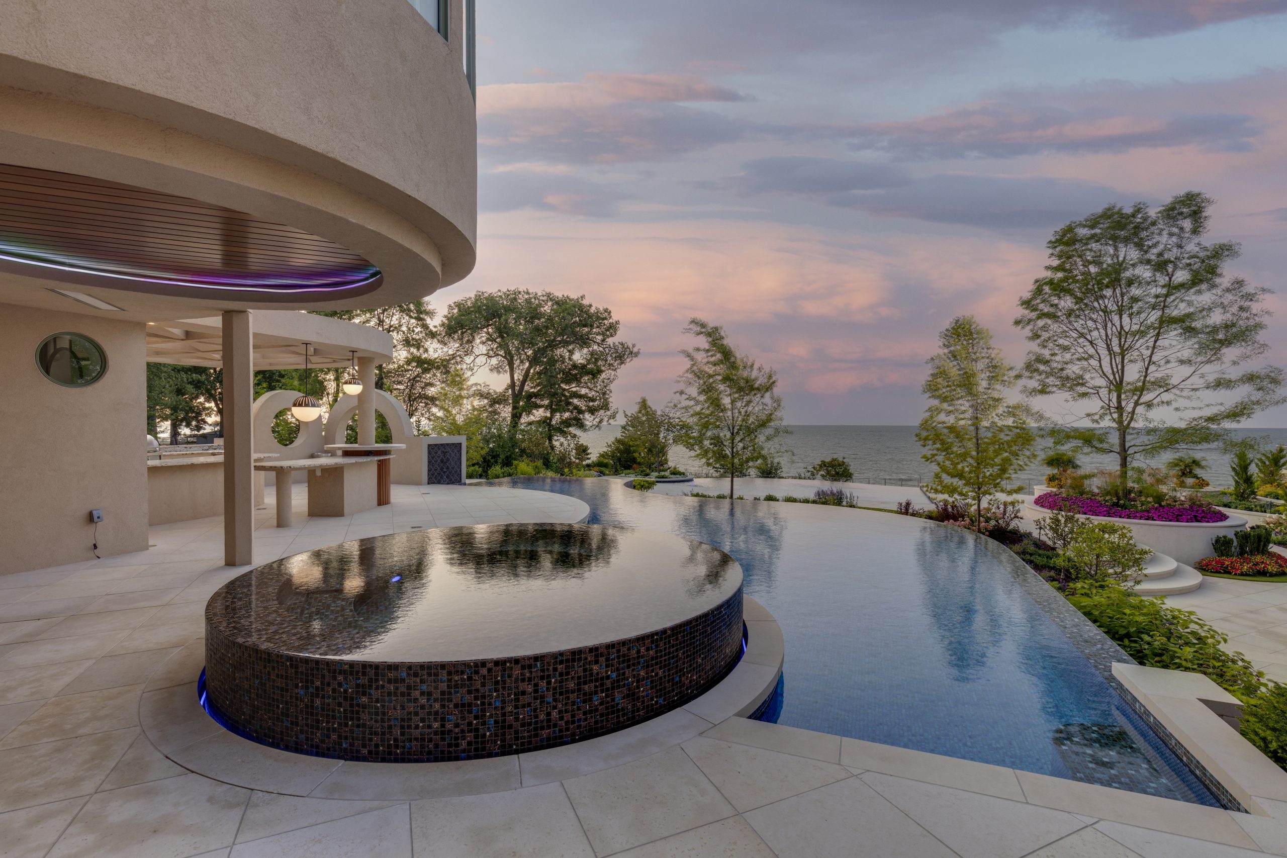a bespoke curved swimming pool looking over the sea