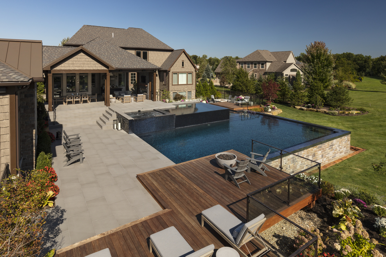 Square outdoor pool outside of a large residential property.