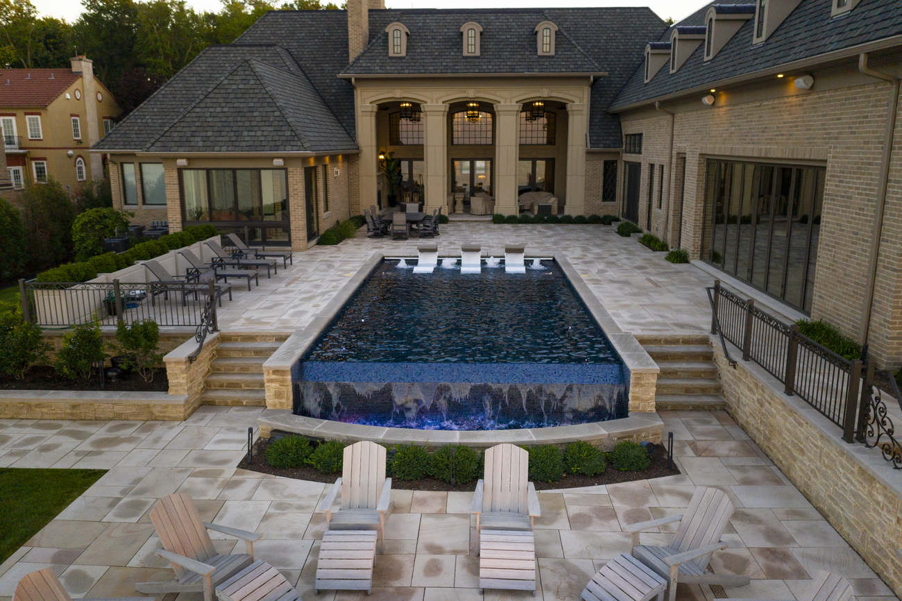 Rectangular swimming pool with a fountain installed at the end.