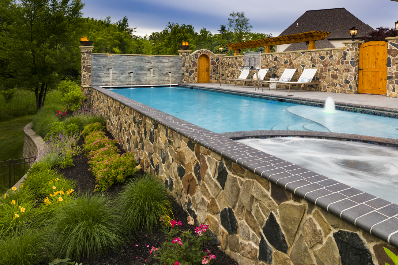 Rectangular residential pool in landscaped garden.