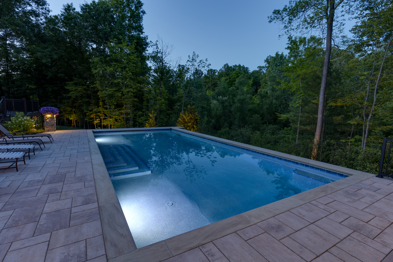 Rectangular residential pool with large patio steps.