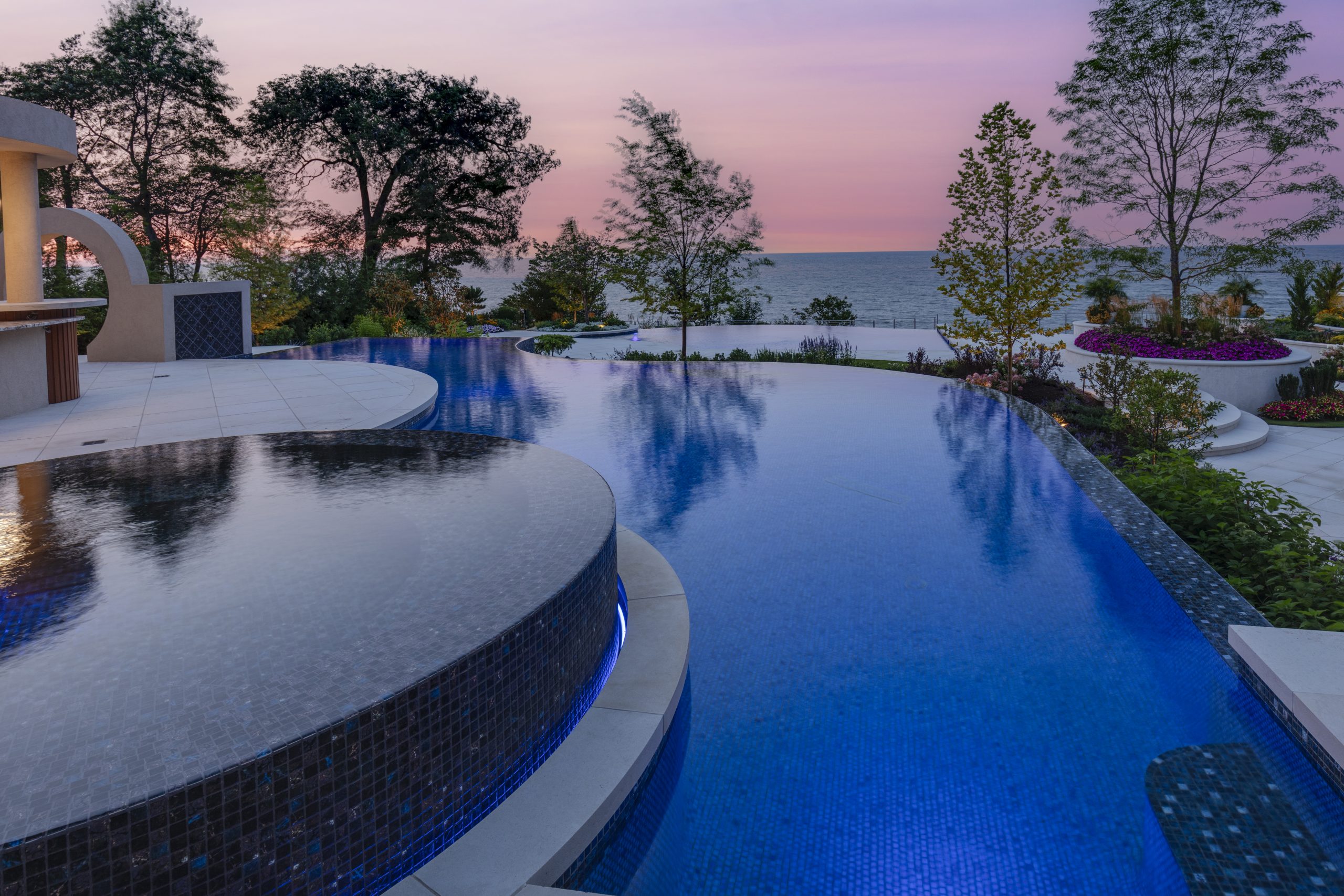 a custom swimming pool with a raised circle infinity spa