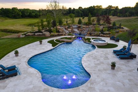 Residential freeform pool at dusk.