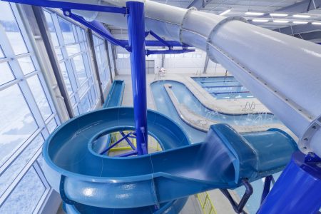 Close up of a slide attached to a commercial indoor pool.