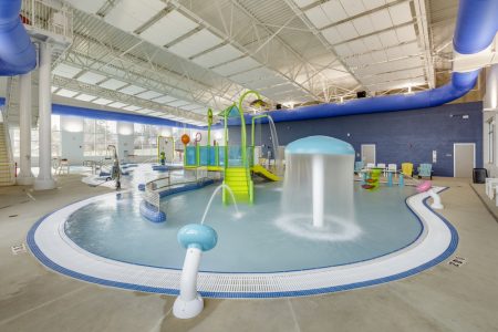 Water fountains installed in a commercial indoor swimming pool.