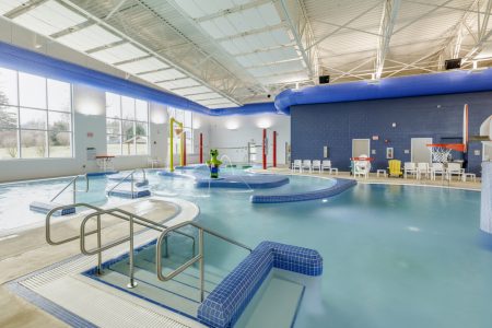Steps into indoor commercial swimming pool installed at the Ray and Joan Kroc Center.